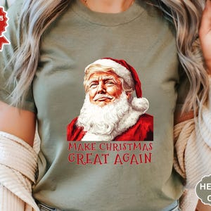 サンタがアメリカを再び偉大にするシャツ、トランプのクリスマスシャツ、トランプのサンタTシャツ、共和党のクリスマスTシャツ、クリスマスを再び偉大にする