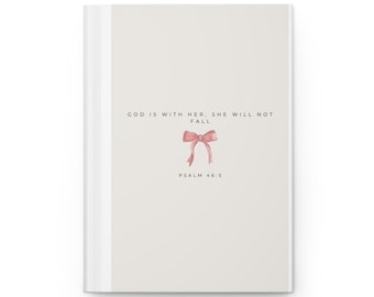 May include: A white journal with a pink ribbon and the text "God is with her, she will not fall. Psalm 46:5"