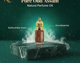 May include: A small, ornate perfume bottle with a gold-colored crown-shaped cap sits on a dark green marble block. The bottle is filled with a reddish-brown liquid. Text reads "Pure Oud Assam Natural Perfume Oil" and "Earthy Amber Scent."