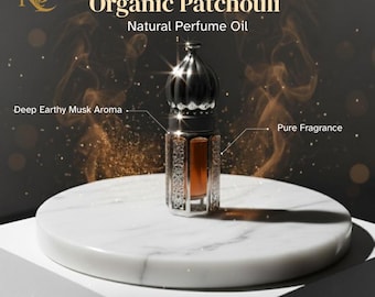 May include: An ornate perfume bottle with a dark cap and silver filigree detailing, filled with amber-colored oil. The bottle sits on a white marble surface. Text reads "Organic Patchouli, Natural Perfume Oil, Deep Earthy Musk Aroma, Pure Fragrance."