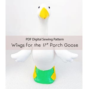 Könnte beinhalten: Ein weißes Plüschgans mit gelbem Schnabel und grünen und gelben Akzenten. Die Gans hat ausgebreitete Flügel und der Text "Wings for the 17" Porch Goose" ist auf dem Bild zu sehen. Es ist ein weiches Stofftier.