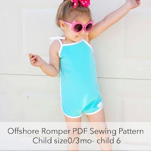 May include: A child wearing a turquoise romper with white trim and straps, paired with pink cat-eye sunglasses and a pink polka-dot bow. The romper has a white tag on the leg. The text on the image reads "Offshore Romper PDF Sewing Pattern Child size 0/3mo- child 6."