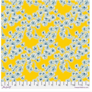 May include: Yellow fabric with a repeating floral pattern. The design features white and blue flowers with delicate stems and leaves. The fabric has a ruler along the bottom edge, with measurements in inches. The text "FreeSpirit Fabrics" is visible.
