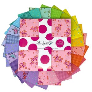 May include: A circular arrangement of colorful fabric squares. The squares feature floral and polka dot patterns in shades of pink, purple, green, and blue. The center displays the text "Free Spirit" and "Tula Pink".