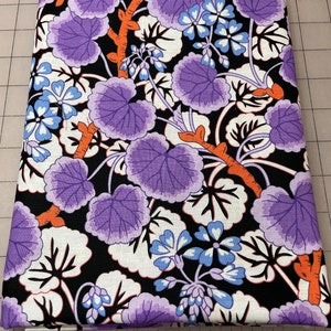 May include: Purple and blue floral fabric with a black background. The fabric features a repeating pattern of large leaves and small flowers.