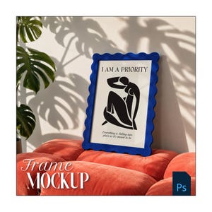 May include: A rectangular picture frame with a wavy, scalloped blue border containing a white print. The print features a black abstract silhouette of a seated figure with the text I AM A PRIORITY and Everything is falling into place as it's meant to be.