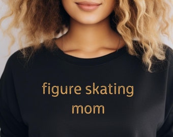 May include: Black sweatshirt with the text "figure skating mom" in gold glitter lettering.