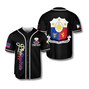 May include: Black baseball jersey with white trim, displaying the Philippines flag and coat of arms. The front has the word "Philippines" in script and a space for a name. The back shows the coat of arms and the words "Republika ng Pilipinas".