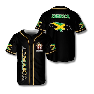 May include: Black baseball jersey with gold trim and the word "JAMAICA" in green and gold. The front features a crest and the text "YOUR NAME". The back displays "JAMAICA" and a map of Jamaica in green and yellow. Sleeves have Jamaican flag accents.