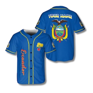 May include: A blue baseball jersey with yellow trim and buttons. The front features the word "Ecuador" in red script and a map of Ecuador. The back displays the text "YOUR NAME" above an emblem with an eagle and a landscape.