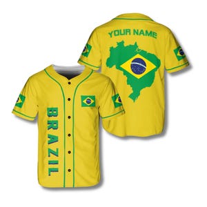 May include: Yellow baseball jersey with green accents and the word "BRAZIL" in green vertical text. The jersey features the Brazilian flag and a map of Brazil. The back of the jersey has the text "YOUR NAME" and a large Brazilian flag.