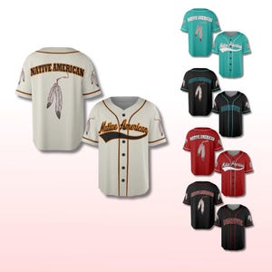May include: Cream-colored baseball jersey with "Native American" text and feather graphics. Additional jerseys in teal, black, and red are also shown. The jerseys have button-up fronts and short sleeves.