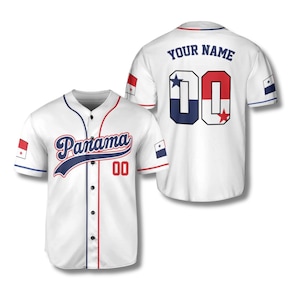 May include: White baseball jersey with the word "Panama" in navy blue script across the chest. The number "00" is in red. The jersey has navy blue and red trim, and the Panama flag is on the sleeves.