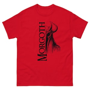 May include: Red t-shirt featuring a black and white illustration of a horned creature, with the word "MORGOTH" printed vertically on the left side.