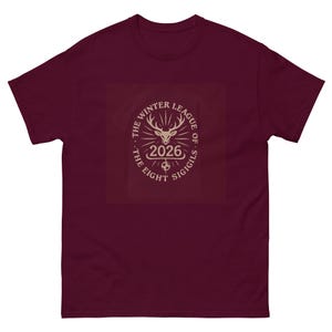 May include: A maroon t-shirt featuring a cream-colored graphic. The graphic includes a deer head with antlers, the year "2026", and the text "THE WINTER LEAGUE OF SIGILS" and "THE EIGHT SIGIGILS".