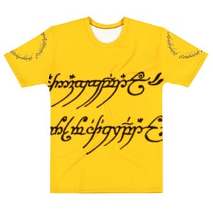 May include: A bright yellow short-sleeved t-shirt featuring black Tengwar script printed across the center of the chest. The same black script is also printed in a circular pattern on both sleeves of the garment, which has a round neckline.