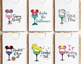 May include: Six white t-shirts with different Disney princess-themed wine glass designs and text. The designs include Ariel, Belle, Cinderella, Elsa, Snow White, and Rapunzel.