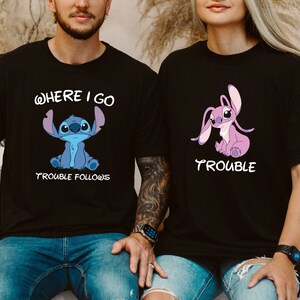May include: Two black t-shirts with a blue and pink Stitch character from the Disney movie Lilo & Stitch. The text on the shirts reads "Where I Go Trouble Follows" and "Trouble".