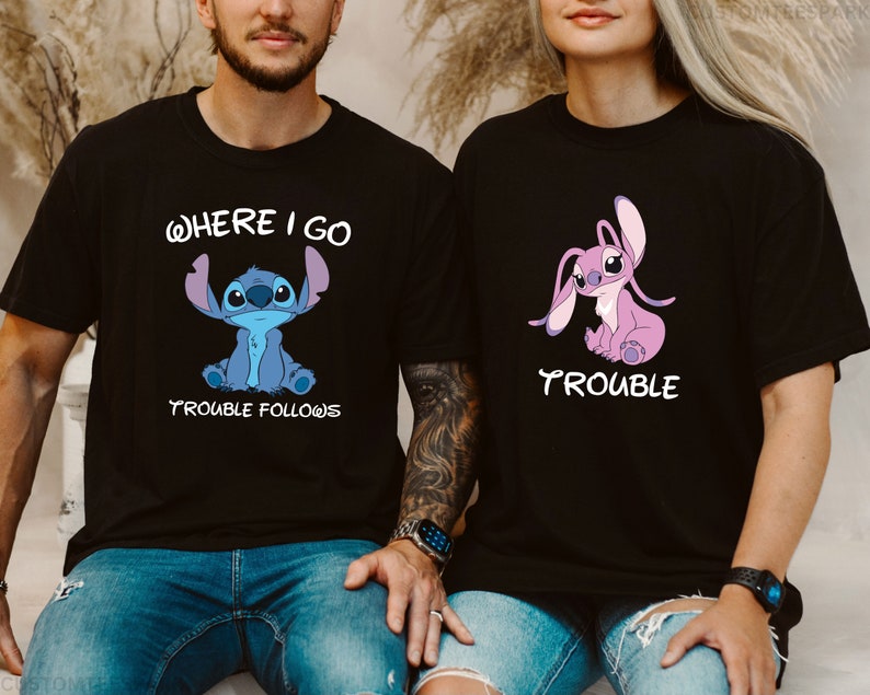May include: Two black t-shirts with a blue and pink Stitch character from the Disney movie Lilo & Stitch. The text on the shirts reads "Where I Go Trouble Follows" and "Trouble".