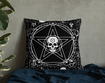 May include: Black and white throw pillow with a skull inside a pentagram and a circle of astrological symbols.
