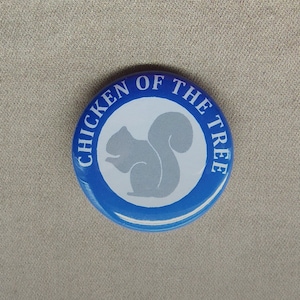May include: Blue and white button with the text "Chicken of the Tree" and a gray squirrel silhouette.