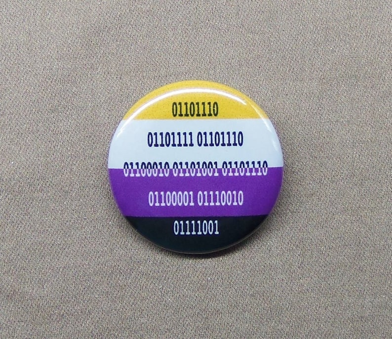 A button with four color stripes: yellow, white, purple and black, the non-binary pride flag colors.  On top of the stripes are 0's and 1's representing the phrase Non-Binary in binary code.  There are five lines of numbers.
