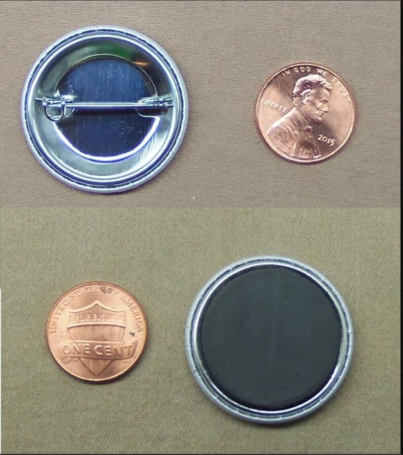May include: A silver-coloured button with a pin back and a black magnet button. Two pennies are next to the buttons for size comparison. The button is round.