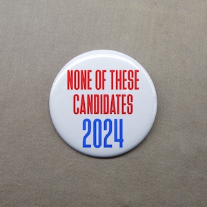 May include: White button with red and blue text that reads "None of these candidates 2024".