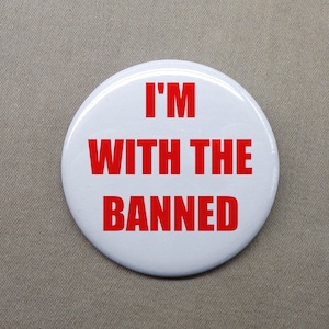 May include: White button with red text that reads "I'm with the banned".