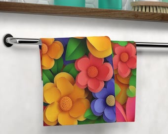 May include: A colorful kitchen towel with a floral design. The towel features a variety of flowers in shades of yellow, red, blue, and green. The flowers are arranged in a random pattern and appear to be made of paper.