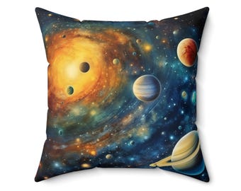 May include: Square cushion with a colourful galaxy design, featuring planets, stars, and swirling nebulae. The cushion has a dark blue background with a central orange and yellow spiral.