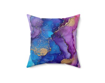 May include: Purple, blue, and gold abstract throw pillow with a marbled design.