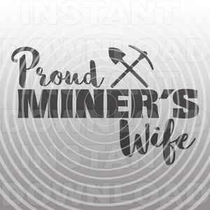 May include: Black and white graphic design with the text "Proud Miner's Wife" and a crossed pickaxe and shovel.