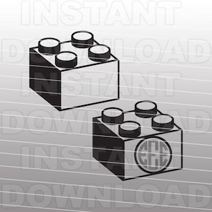 May include: Two black plastic toy building blocks. The top block has four studs. The bottom block has four studs and a circle in the center with the letters "EEE" inside.