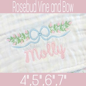 May include: Embroidered design featuring a light blue bow and a floral vine with pink rosebuds and green leaves. The name "Molly" is embroidered in pink script. The text "Rosebud Vine and Bow" and size options are also displayed.