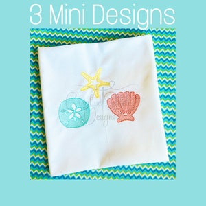 May include: Three mini embroidery designs featuring a yellow starfish, a blue seashell, and a pink seashell on a white fabric background.