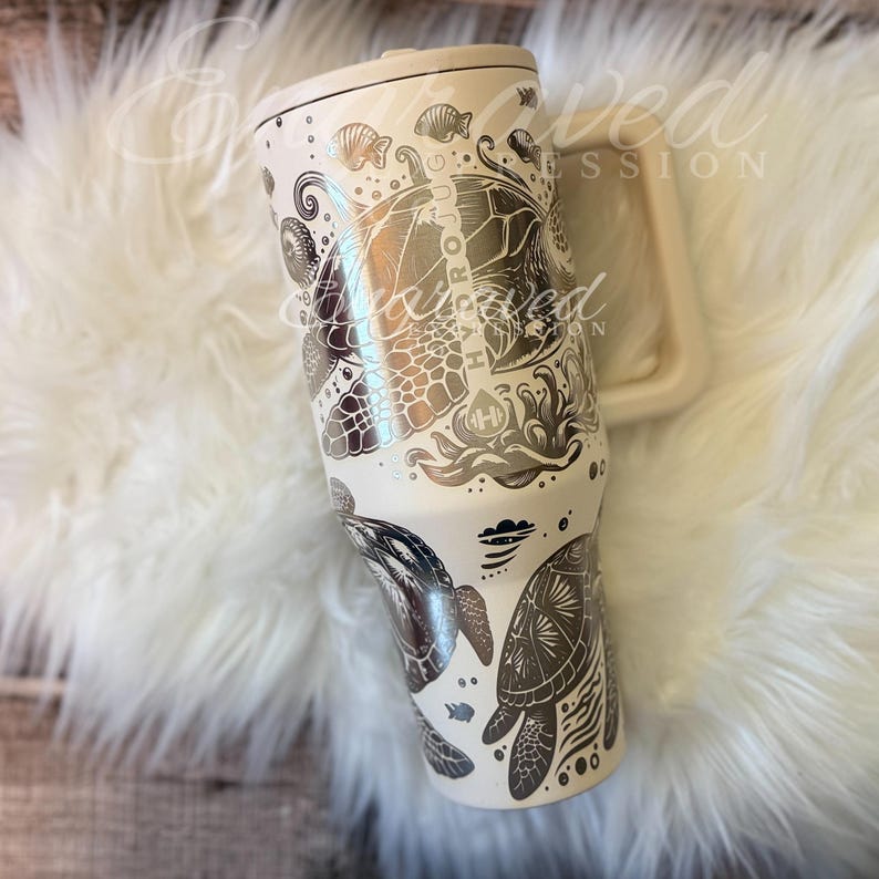 A white ceramic mug with a detailed, hand-painted design featuring various marine life and ocean-themed elements.