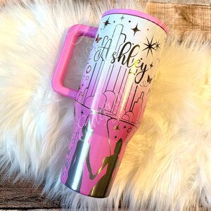 A pink and white tumbler mug with a personalized design featuring silhouettes of two people holding hands and stars.