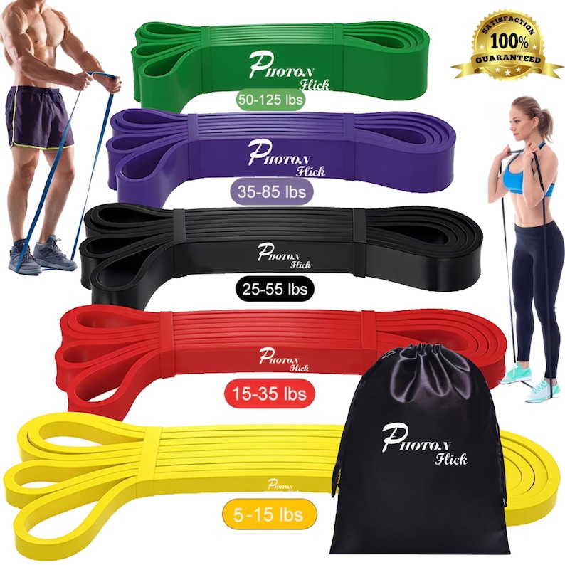 May include: Set of five resistance bands in yellow, red, black, purple, and green. The bands are labeled with their resistance levels: 5-15 lbs, 15-35 lbs, 25-55 lbs, 35-85 lbs, and 50-125 lbs. The bands are packaged in a black drawstring bag with the brand name "Photon Hick" printed on it.