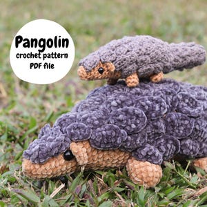 May include: A handmade crochet pangolin, with a smaller version riding on top. The larger pangolin is gray with tan accents, and the smaller one is a similar color. The text "Pangolin crochet pattern PDF file" is in a white circle.