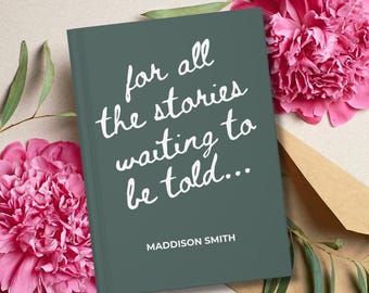 May include: A dark green hardcover book with white text that reads "for all the stories waiting to be told..." and "MADDISON SMITH" printed in a clean sans-serif font at the bottom, positioned among bright pink peony flowers and green leaves.