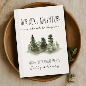 May include: A white book with the text "OUR NEXT ADVENTURE is about to begin" in black. Below the text is a watercolor painting of evergreen trees. The bottom of the book reads "WISHES FOR THE FUTURE PARENTS Sally & Harry."