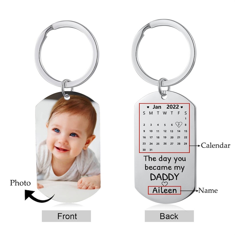 May include: A silver-colored keychain with a rectangular tag. One side features a baby photo, the other side has a calendar for January 2022, the text "The day you became my DADDY," and the name "Aileen."