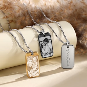 May include: Three silver chain necklaces with rectangular pendants. Two pendants feature black and white photos, and one pendant has the name "David Richards" engraved on it.