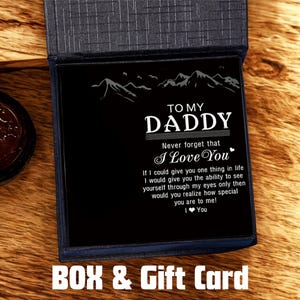 May include: A black gift card inside a blue box, with the words "TO MY DADDY" and a heartfelt message. The card features a mountain range design and the text "I Love You". The words "BOX & Gift Card" are at the bottom.