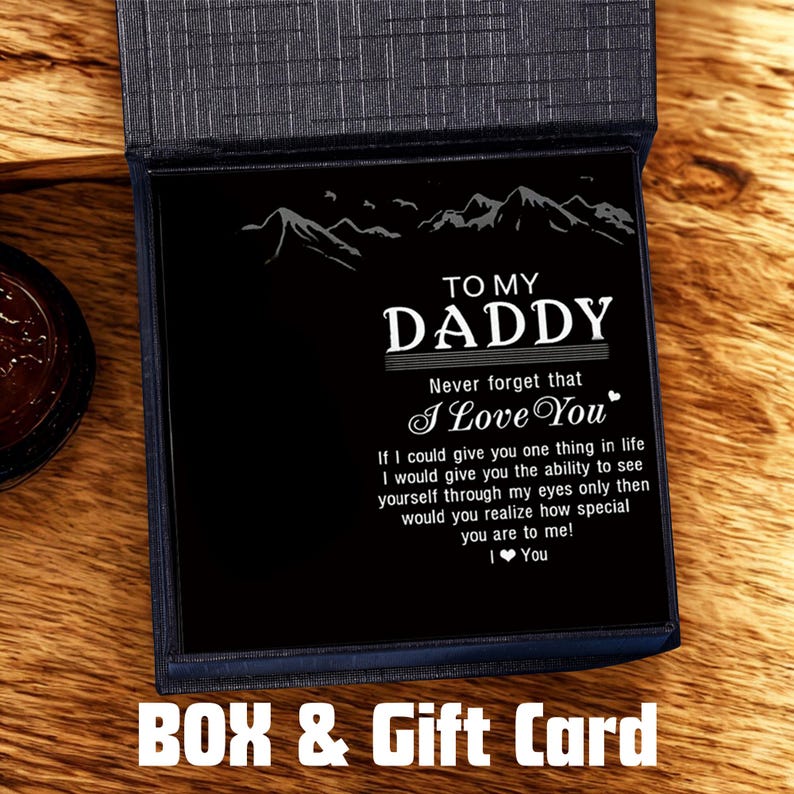 May include: A black gift card inside a blue box, with the words "TO MY DADDY" and a heartfelt message. The card features a mountain range design and the text "I Love You". The words "BOX & Gift Card" are at the bottom.