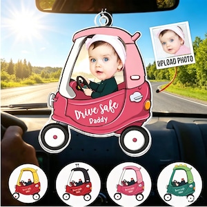 May include: A pink car-shaped car air freshener with a baby's photo inside. The text "Drive Safe Daddy" is displayed on the car. Additional car designs in yellow, black, pink, and green are shown below.