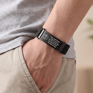 May include: A black medical alert bracelet featuring a rectangular metal plate with a white Star of Life symbol and engraved text: Kelsey Type2 Diabetes, Allergic to Penicillin, ICE:Chris 123-456-7890, Stacy 098-765-43321, See Wallet for Meds.