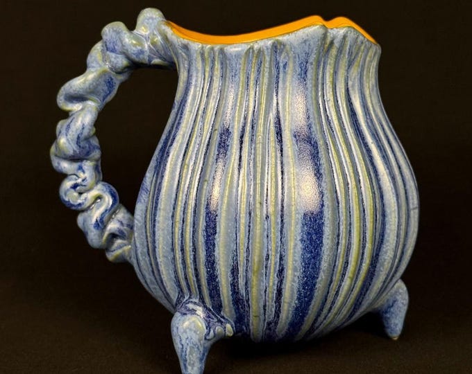 handmade whimsical porcelain mug in blue and orange