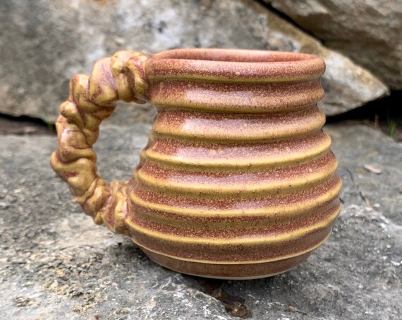 small ceramic mug in mauve and cream